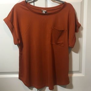 Burnt orange shirt with rolled sleeves and pocket